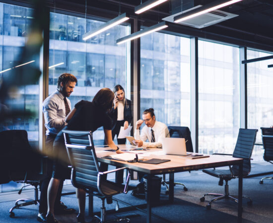 Square image Engineering firm team reviewing an RFP proposal around a conference table